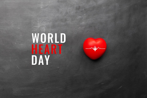 Photo world heart day background with a red heart on black