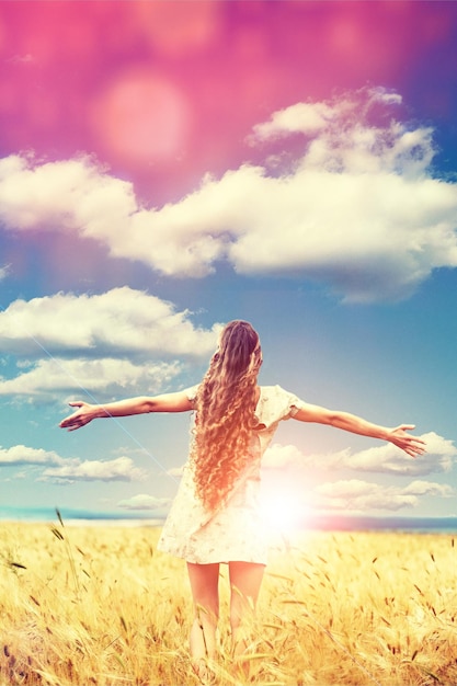 World mental health day concept: Silhouette of healthy woman raised hands at meadow background