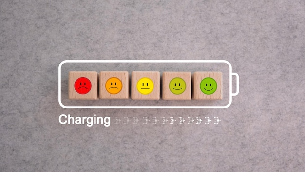 Photo world mental health day emotion wooden blocks in status charging battery angry indifferent smiling t