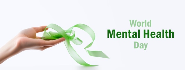 Photo world mental health day web banner with green awareness ribbon in female hand woman holding green ribbon at white background