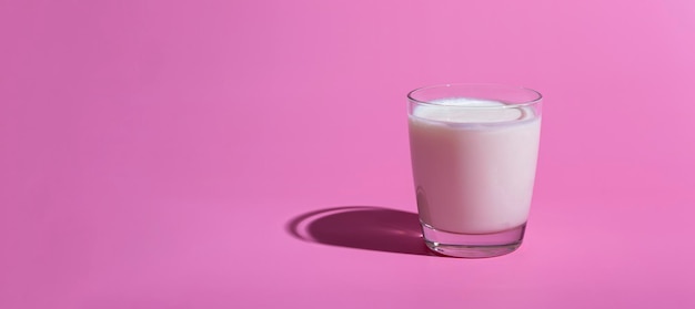 World Milk Day. Pattern on a pink background. A glass of milk. Sample. Banner