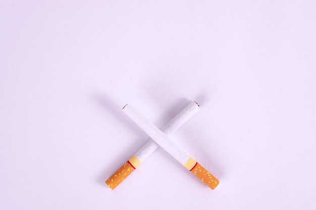 World No Tobacco Day, Two cigarette crossed slashes, Concept of no smoking on white background.