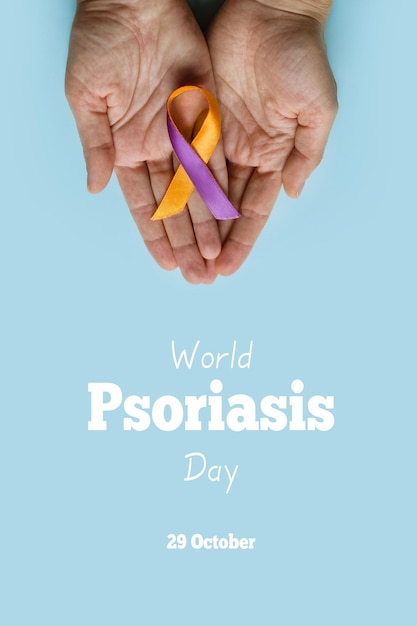 World Psoriasis Day Woman's hands are holding  purple orange ribbon on blue background