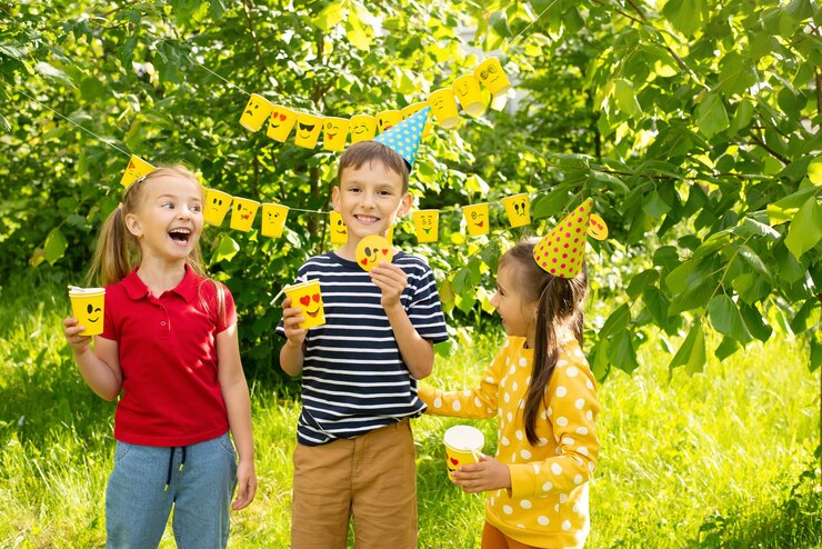 World Smile Day and holidaychildren have fun at a picnica cheerful company of children show emojis