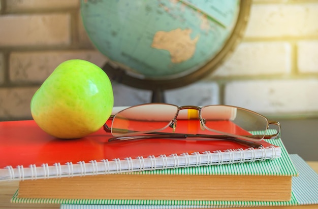 World teacher's Day at school Still life with books globe Apple glasses sunlight