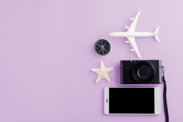 World Tourism Day model plane airplane starfish alarm clock compass and smartphone blank screen