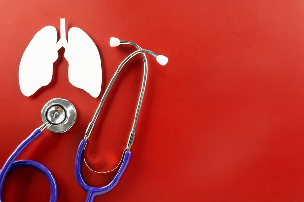 World tuberculosis day lungs paper cutting symbol and medical stethoscope on red background copy