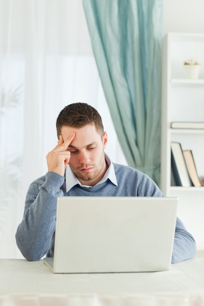 Worn out businessman on his laptop in his homeoffice