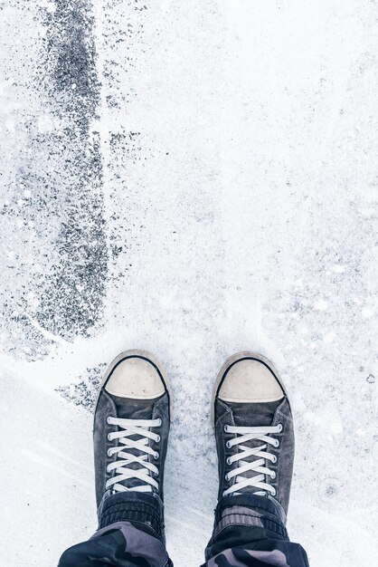 Photo worn sneakers on grunge pavement