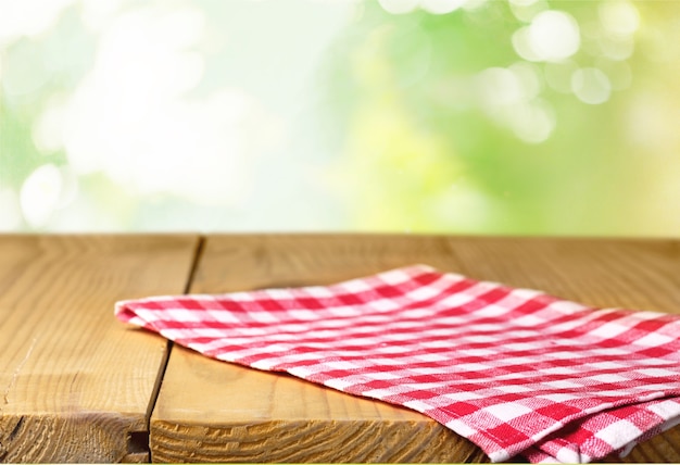 Worn table and blur with bokeh grass background