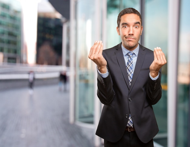 Worried businessman doing a puzzled gesture