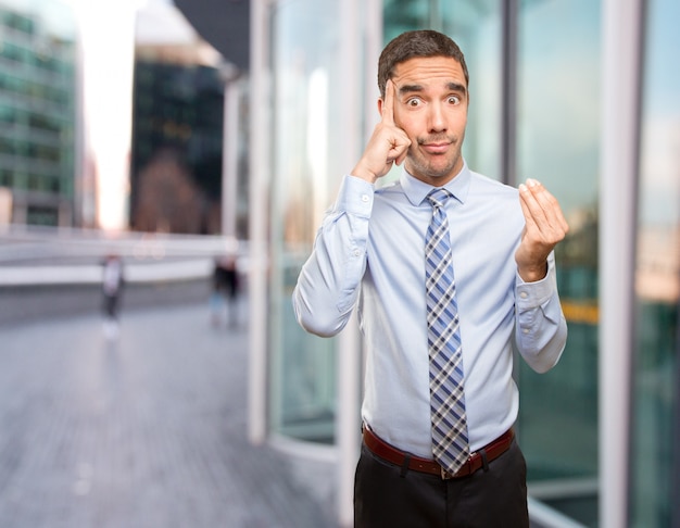 Worried businessman doing a puzzled gesture
