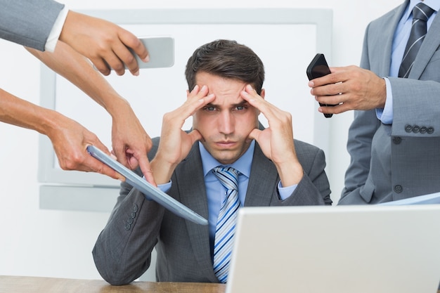 Worried businessman with head in hands