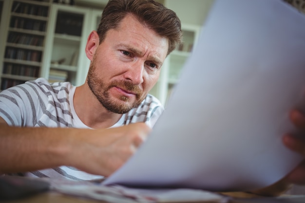 Worried man looking at his bills