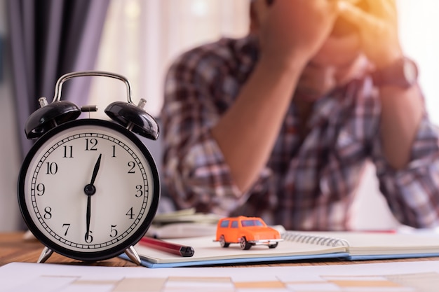 Worried man with classic clock.