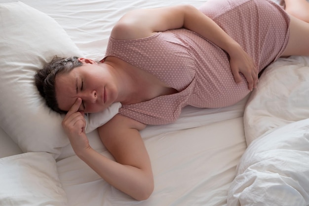 Worried pregnant woman in the bed suffering from insomnia