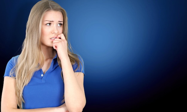 Worried Pretty young thoughtful woman on background