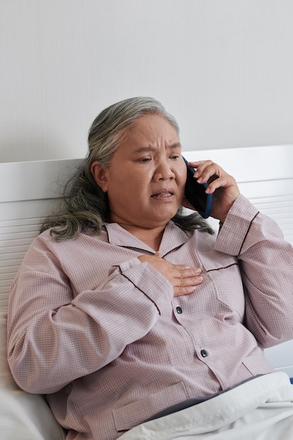 Worried Senior Woman Calling Doctor