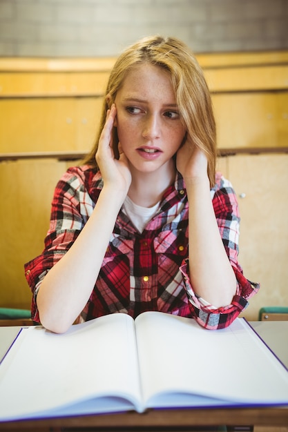Worried student studying on notebook