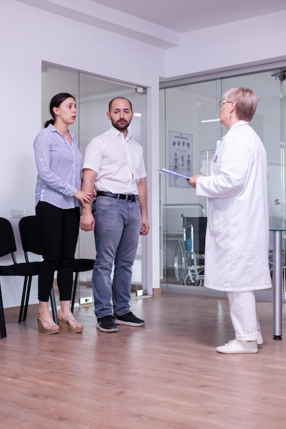 Worried woman looking at doctor waiting for medical results