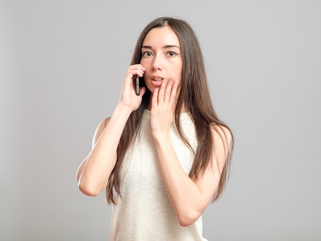 Worried young woman talking on the phone