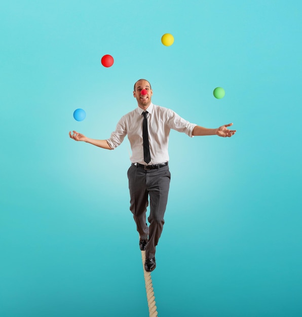 Worry man in balance walking on a rope overand acts like a\
juggler