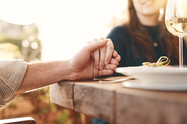 Worship table and people holding hands to pray for the meal feast or dinner at an event Prayer celebration and christian family praying for the food before eating at party celebration or banquet