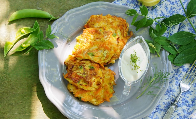 Wortel, courgette en groene erwten beignets met griekse yoghurt