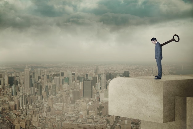 Wound up businessman with hands in pockets against balcony overlooking city