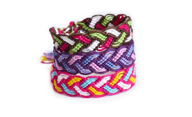 Woven DIY friendship bracelets handmade of embroidery bright thread with knots on white