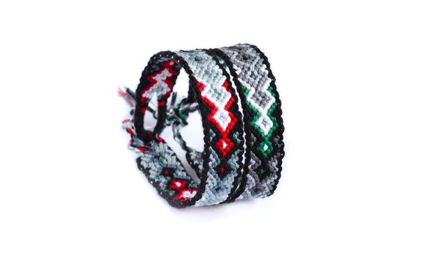 Woven DIY friendship bracelets handmade of embroidery bright thread with knots on white