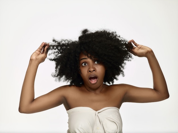 Wow. Beautiful female half-length portrait isolated on white  backgroud. Young surprised woman holding hands by head, . Human emotions, facial expression concept.