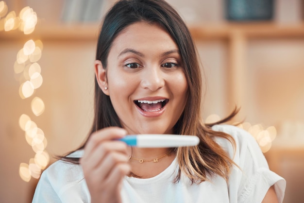 Wow excited or woman with pregnancy test results by reading a fertility stick at home with a happy smile Face pregnant or surprised person in maternity shocked by motherhood or future family news