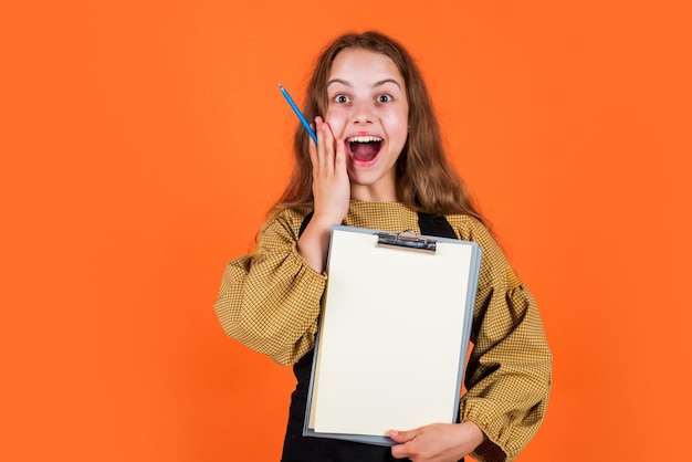 Wow office life get knowledge from archive Young business kid holding folder happy brunette girl with folder of documents in her hands teen kid holds folder in hands copy space