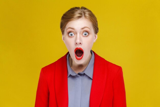 Wow red head woman in red suit amazement open mouth