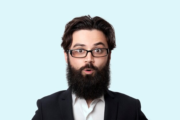 Wow! Surprised bearded businessman in glasses with open mouth, close up portrait