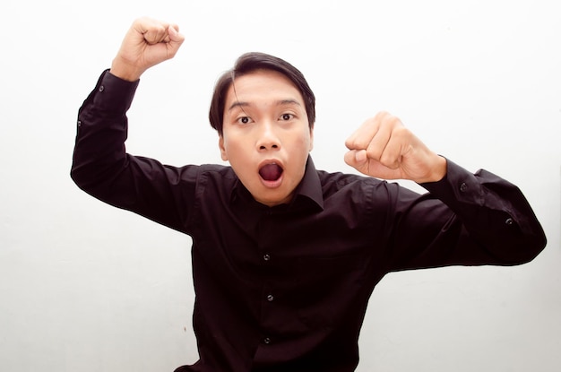 wow surprised and shocked face of young asian man isolated over white background.