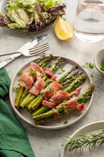 Wrapped asparagus with bacon in a plate Top view