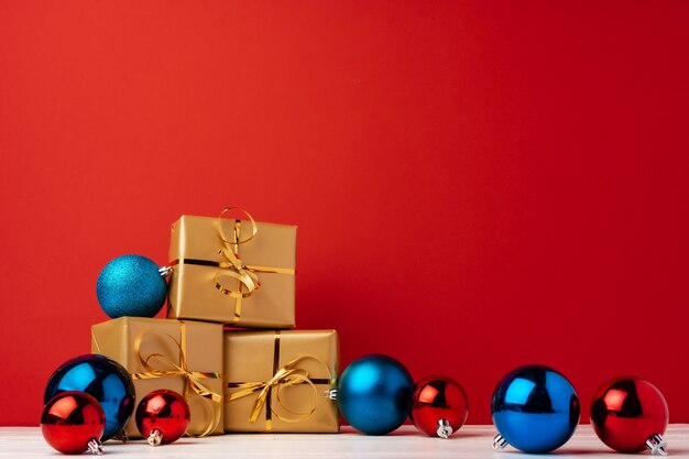 Wrapped christmas gift boxes against red background front view