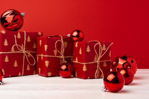 Wrapped christmas gift boxes against red background