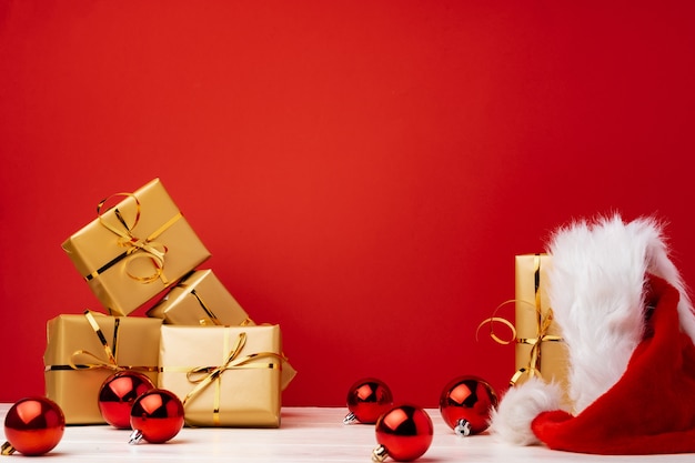 Wrapped christmas gift boxes against red background