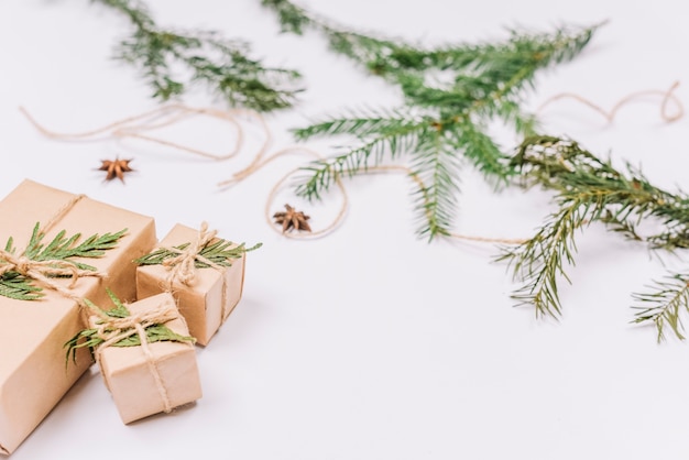 Photo wrapped christmas gifts near coniferous twigs