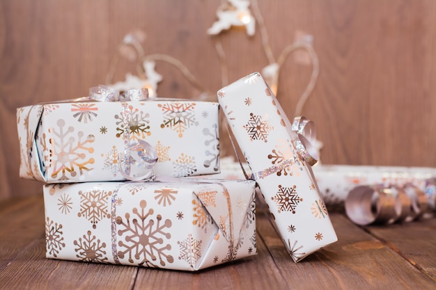 Photo wrapped in festive packaging gift boxes tied with silver bow