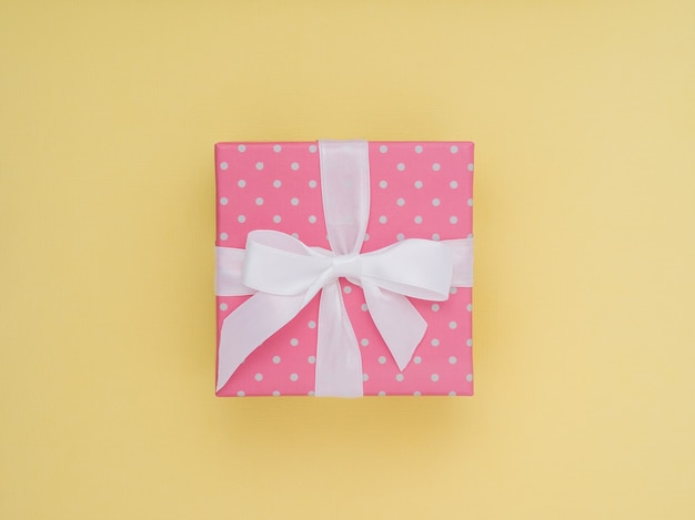 Wrapped gift box. Pastel Colour flat lay minimal concept.