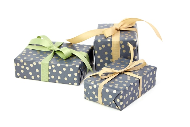 Wrapped gift boxes isolated on white Three green gift boxes with ribbon bows Christmas present