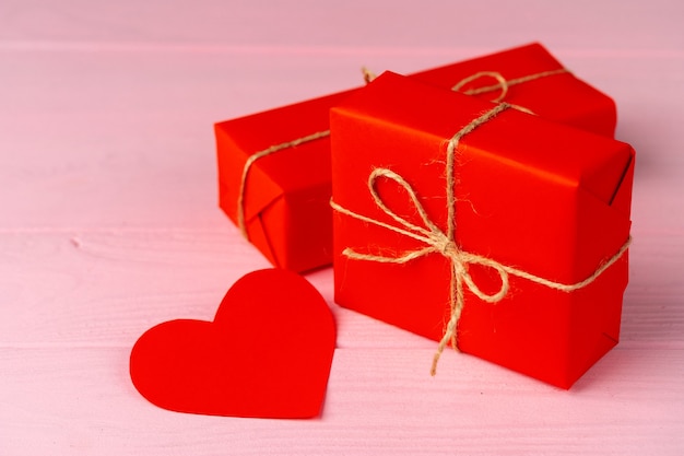 Wrapped gift for Valentine's day on wooden table close up