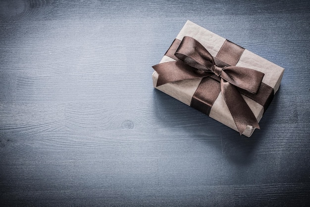 Wrapped present box on vintage wooden board holiday concept