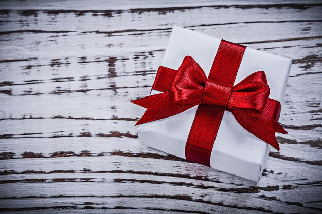 Wrapped present box on vintage wooden board holidays concept