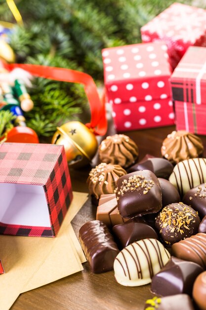 Wrapping assorted chocolates in small boxes for Christmas presents.