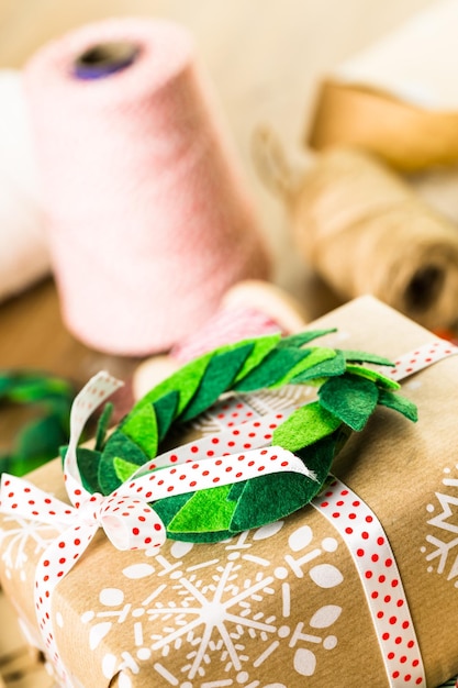 Photo wrapping christmas gifts in recycled brown paper with vintage style at home.